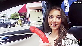 Hot Brunette In A Car With Red Dildo